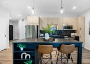 Thumbnail 1 of 64 - a kitchen with a blue island and three stools