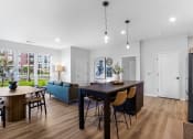 Thumbnail 2 of 64 - a living room and dining room with a table and chairs
