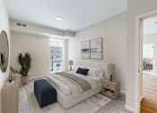 Thumbnail 42 of 64 - A bedroom with a large bed and a mirror on the wall.