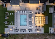 Thumbnail 57 of 64 - A modern house with a pool and a patio area.
