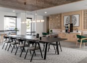 Thumbnail 9 of 64 - A modern dining area with a long table and chairs.