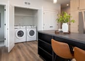 Thumbnail 30 of 64 - A laundry room with a washer and dryer in it.