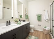 Thumbnail 32 of 64 - A bathroom with a white sink and a toilet.