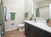 Thumbnail 34 of 64 - A bathroom with a white toilet and a white sink.