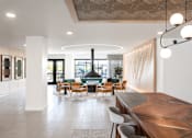 Thumbnail 8 of 64 - A modern living room with a large wooden table and a curved sofa.