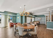Thumbnail 5 of 102 - A dining room with a round table and chairs.