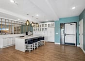Thumbnail 3 of 102 - A kitchen with white cabinets and a blue wall.