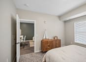 Thumbnail 94 of 102 - A bedroom with a bed, dresser, and a window with blinds.