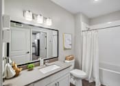 Thumbnail 96 of 102 - A white bathroom with a sink, toilet, and bathtub.