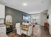 Thumbnail 89 of 102 - A modern dining room with a glass table and white chairs.