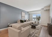 Thumbnail 80 of 91 - A living room with a grey wall and a white couch.