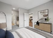 Thumbnail 59 of 91 - A bedroom with a large bed and a mirror on the wall.
