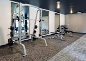 Thumbnail 58 of 60 - Weights in Fitness Room at The McMillan Apartments in Shoreview, MN 55126