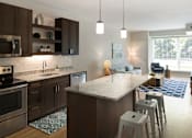 Thumbnail 29 of 60 - Kitchen Island Near Living Room at The McMillan Apartments in Shoreview, MN 55126