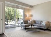 Thumbnail 40 of 60 - Living Room With Patio/Balcony at The McMillan Apartments in Shorview, MN 55126