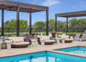 Thumbnail 86 of 105 - a pool and lounge area with couches and chairs at The Gateway at West Lake Quarter in Minneapolis, MN