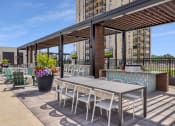 Thumbnail 87 of 105 - a patio with a table and chairs and a bar at The Gateway at West Lake Quarter in Minneapolis, MN