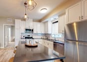 Thumbnail 4 of 91 - a kitchen with white cabinets and stainless steel appliances at The Morrison, Rosemount, 55068