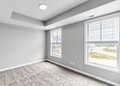 Thumbnail 44 of 97 - A room with a window showing a view of a street.
