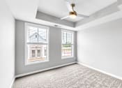 Thumbnail 21 of 97 - A room with a carpeted floor and a ceiling fan.