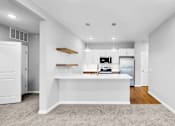 Thumbnail 18 of 97 - A white kitchen with a white island and a white fridge.