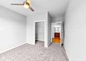 Thumbnail 10 of 97 - A room with a ceiling fan and a carpeted floor.