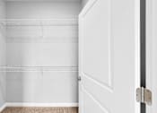 Thumbnail 11 of 97 - Empty white closet with a door open.
