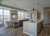 Thumbnail 10 of 45 - A modern kitchen with a white island and stainless steel appliances.