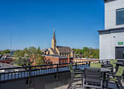 Thumbnail 27 of 45 - A church steeple is visible behind a building with a balcony.