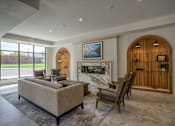 Thumbnail 1 of 45 - A living room with a fireplace and a couch.