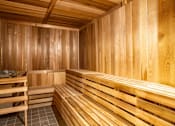 Thumbnail 8 of 45 - A wooden sauna with benches and a tiled floor.