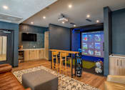Thumbnail 5 of 45 - A modern living room with a leather couch and a television.
