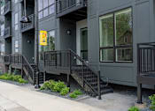 Thumbnail 45 of 45 - A building with a yellow sign on the balcony.