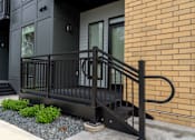 Thumbnail 41 of 45 - A black metal railing on a brick building.