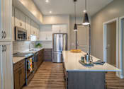 Thumbnail 14 of 45 - A modern kitchen with wooden cabinets and a stainless steel refrigerator.