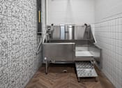 Thumbnail 57 of 69 - A stainless steel sink in a tiled room with a wooden floor.