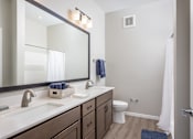 Thumbnail 21 of 69 - A bathroom with a white toilet and a white sink.