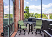 Thumbnail 28 of 69 - A patio with a table and two chairs.