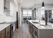 Thumbnail 14 of 69 - A modern kitchen with dark wood cabinets and a white countertop.