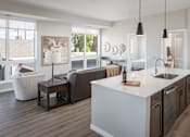 Thumbnail 15 of 69 - A modern kitchen with a large island and a view of the backyard.