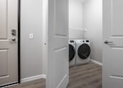 Thumbnail 27 of 69 - A laundry room with a washer and dryer.