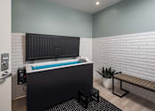 Thumbnail 38 of 69 - A modern bathroom with a black tub and a bench.