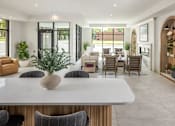 Thumbnail 32 of 69 - A modern dining room with a marble table and grey chairs.