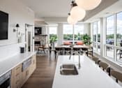 Thumbnail 51 of 69 - A modern kitchen with a large island and a dining table.