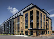 Thumbnail 69 of 69 - A large multi-story building with the word "Warnock" on the front.