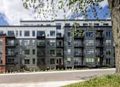Thumbnail 65 of 69 - A modern building with a mix of brick and dark facades.