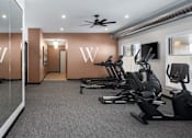 Thumbnail 42 of 69 - A gym with treadmills and exercise bikes.