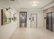 Thumbnail 37 of 69 - A hallway with a white wall, a painting, and two doors.