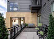 Thumbnail 10 of 69 - A balcony with a table and chairs overlooking a street.
