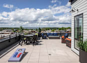 Thumbnail 54 of 69 - A patio with a table and chairs overlooking a town.